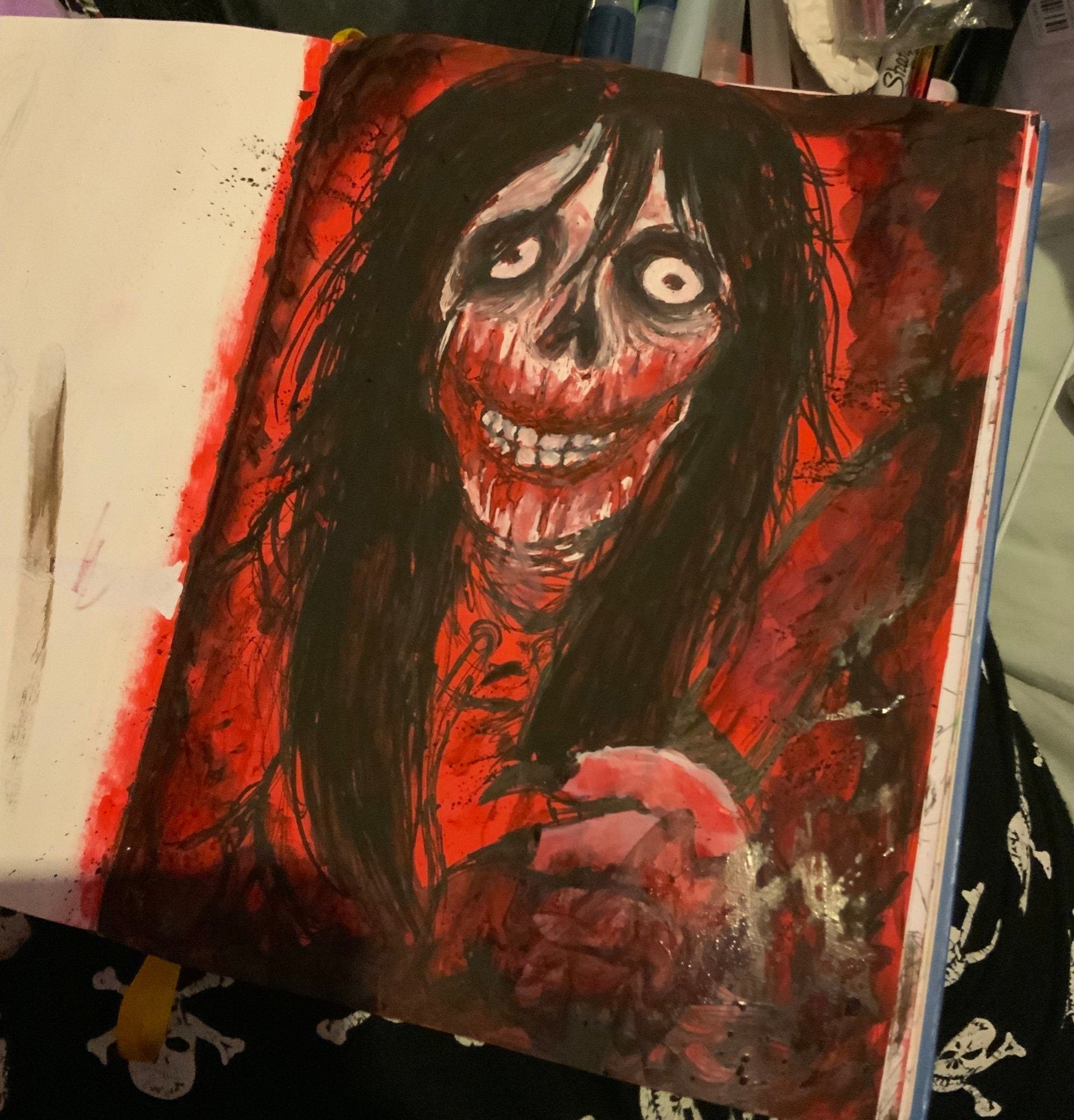 Artistic depiction of a character with dark hair and red accents in a sketchbook