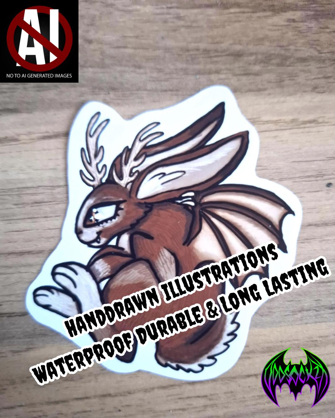 Handdrawn illustration of a brown  rabbit creature  with bat wings & antlers  on a wooden surface with text "Handdrawn Illustrations , waterproof durable & long lasting
